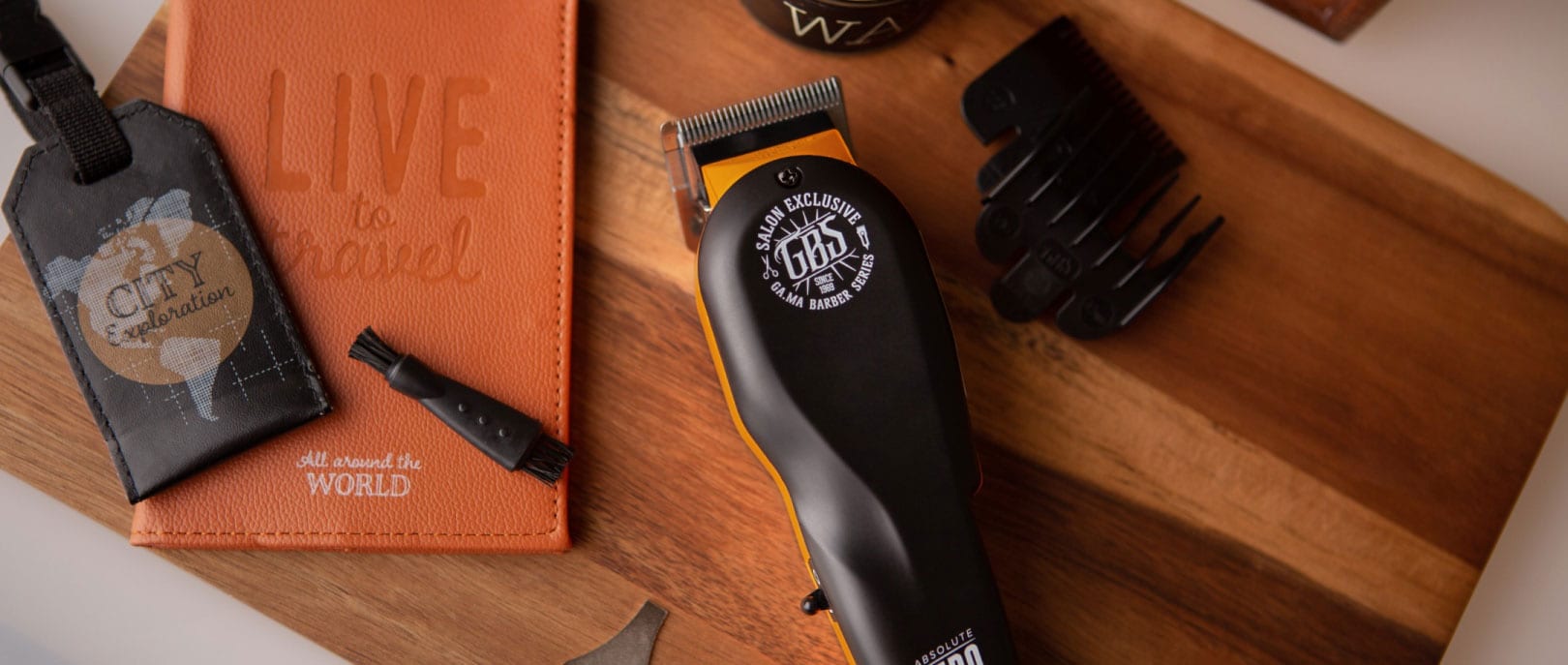 Clippers, guards and combs laid out on the barber's counter