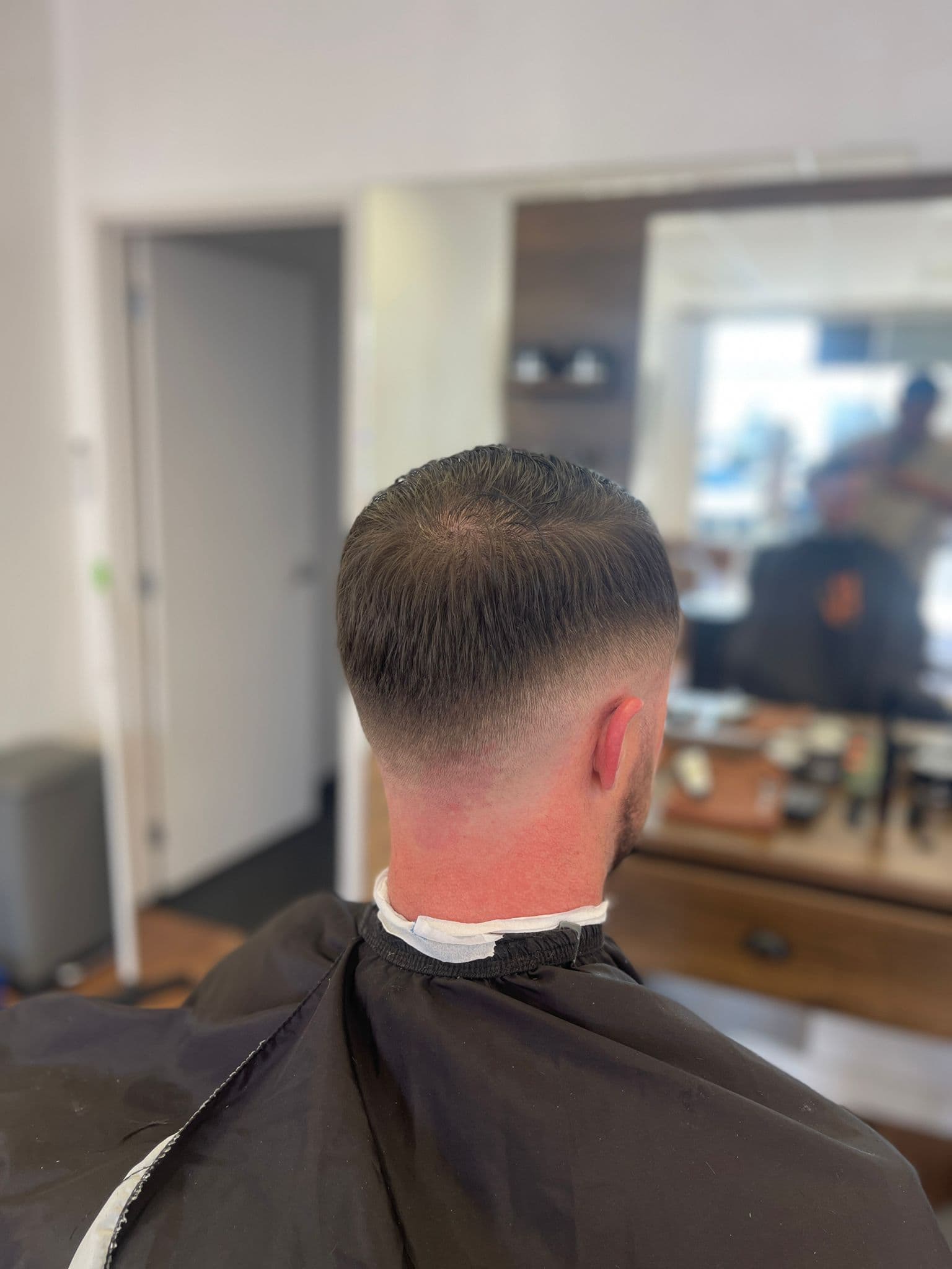 Burst fade tapering cleanly into the neckline