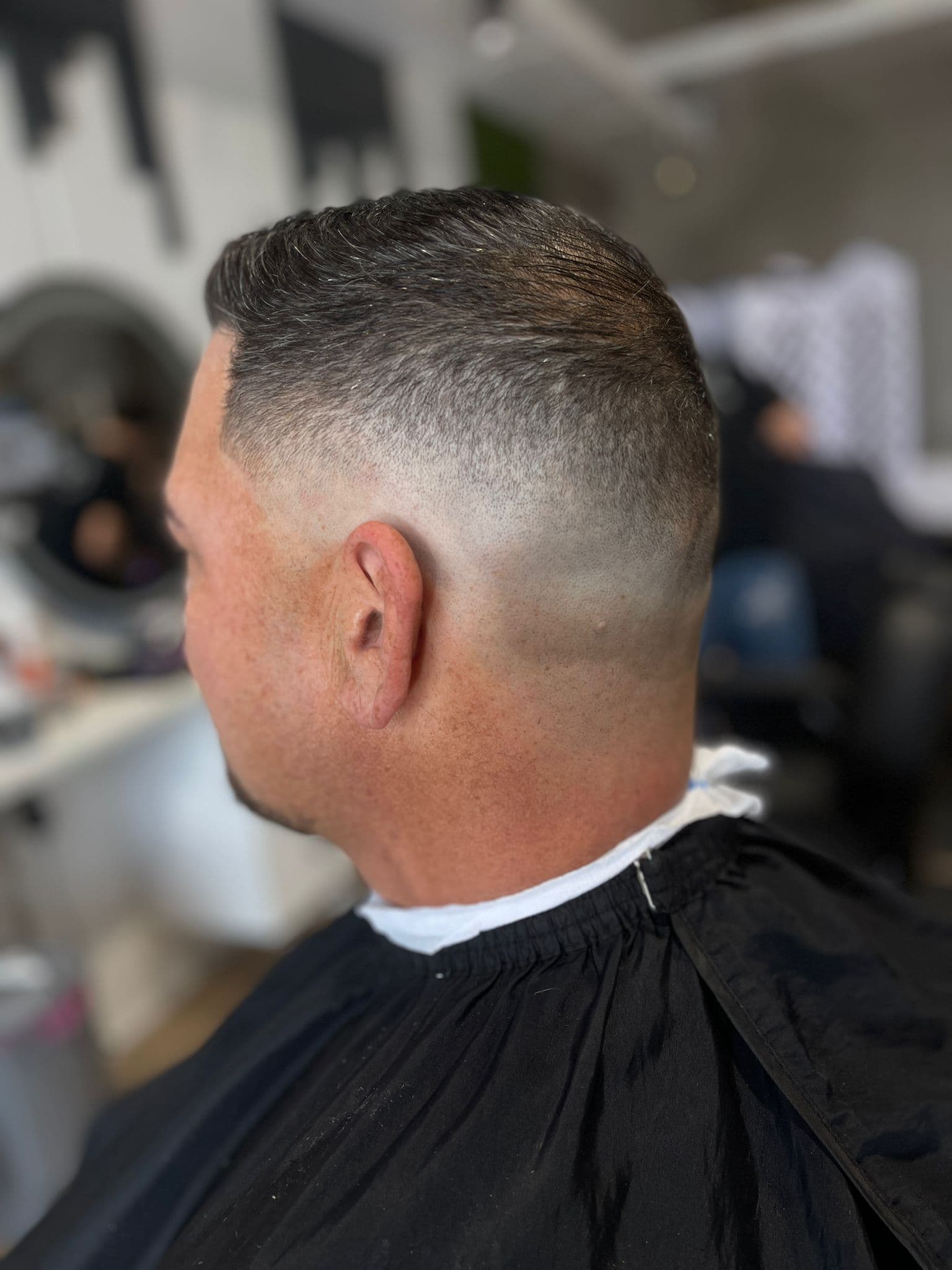 Close skin fade blended into a clipper cut on top